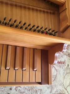 Detail image of harpsichord keys and tuning pegs