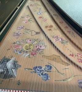 Image of a painted harpsichord soundboard.